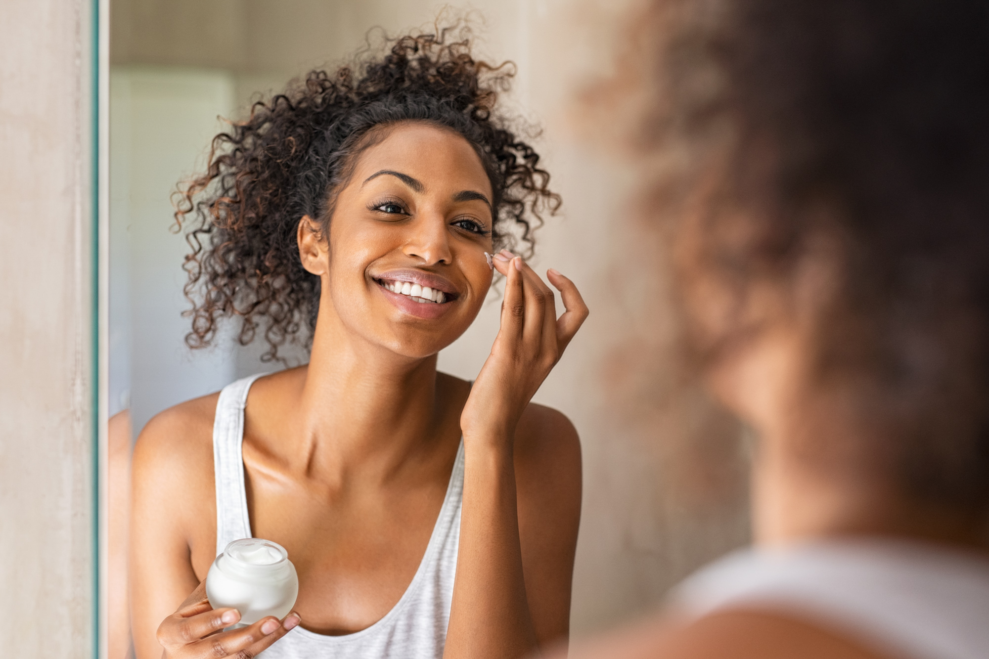 A client applies medical-grade skincare to maintain the results of her treatments for facial volume loss in Lancaster.