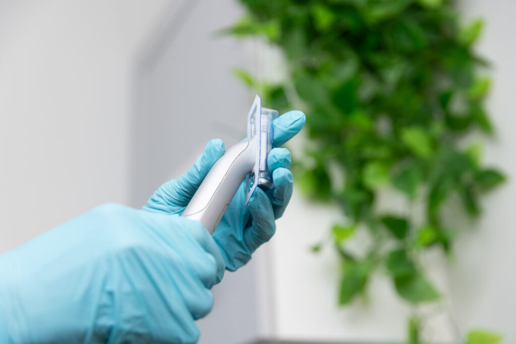 A provider at Medical Spa NP holds up a stamp for microneedling in Columbus.