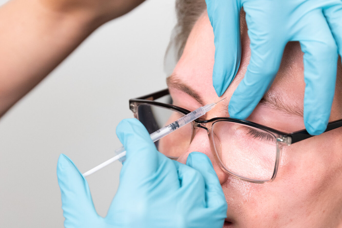 A provider injects a client's forehead with Botox near Columbus.